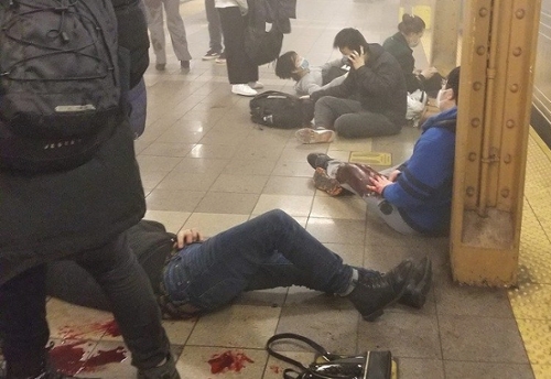 people sitting on the floor in NYC subway, blood in foreground