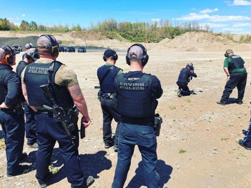 photo of police practicing at an outdoor range in a sandlot